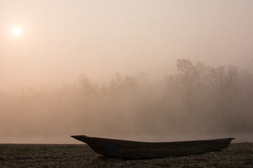 boat at the bank in the morning fog