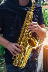 Close up of saxophone player's hands playing jazz music. Street saxophonist playing sax alto