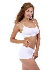 Fototapeta premium Young beautiful blonde woman in white fitness clothing
