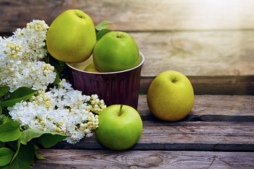 Green organic healthy apples  on wooden board.