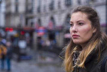 Portrait of a young blonde woman in a big city