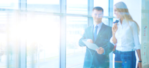 Businesspeople walking in the corridor of an business center