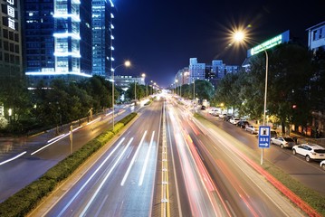 Fototapeta na wymiar Nighttime city traffic with car light trails.