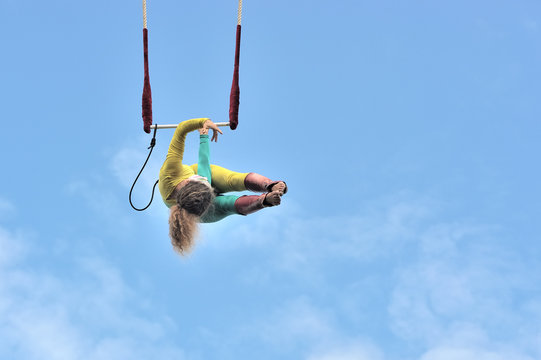 eire square, Galway, Ireland July , art Festival 2017, Mobile Home, trapeze girl artist hanging with one arm with the body at 90 degree at 100 ft high