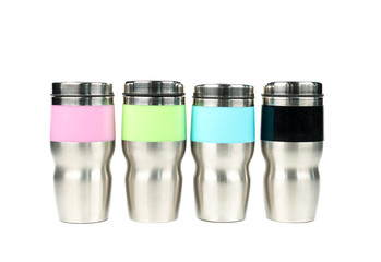 Pink, green, blue and black thermos bottles on white background with copy space