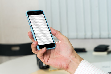 Mock up image of businessman holding mobile phone