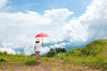 Woman Enjoying Nature on grass meadow on top of mountain in Thailand