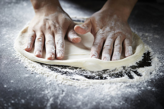 hands kneading dough