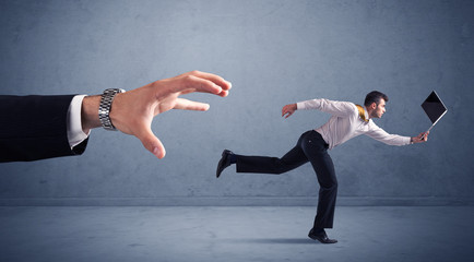 Fototapeta premium Businessman running from hand