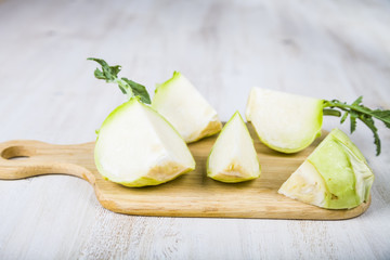 Chopped kohlrabi and knife on chopping board