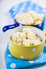 Boiled cauliflower in multi-colored bowls