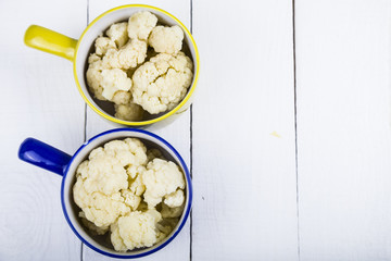 Boiled cauliflower in multi-colored bowls
