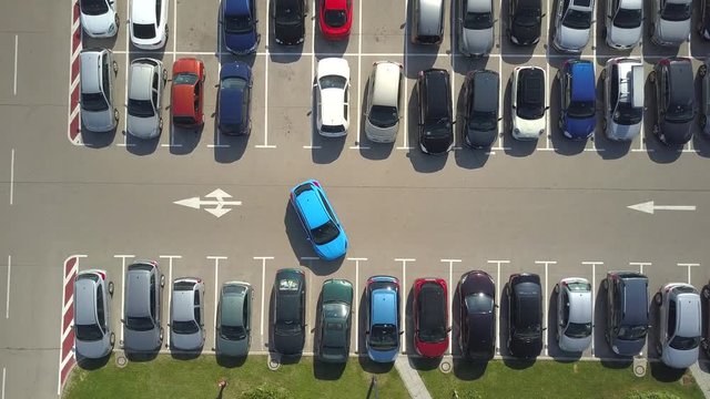 AERIAL TOP DOWN, TIMELAPSE: Bad driver incapable to park a car on parking space in big crowded parking lot. Female having problems, unable to park a car in parking spot. Parking fail on park space