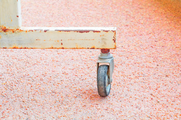 black rubber wheel rusty old small metal transportation metal on floor sandstone