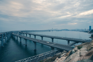 Fototapeta na wymiar Dalian Cross-Sea Bridge against cloudy sky,China.