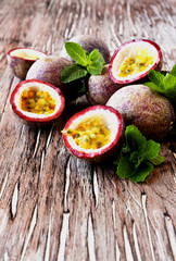 juicy fruit Granadilla with mint on a wooden table