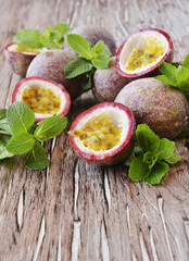 juicy fruit Granadilla with mint on a wooden table