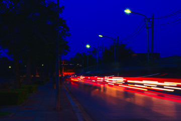 car lights at night in city and headlights. Long exposure with copy space add text