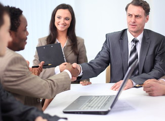 handshake business partners at a business meeting