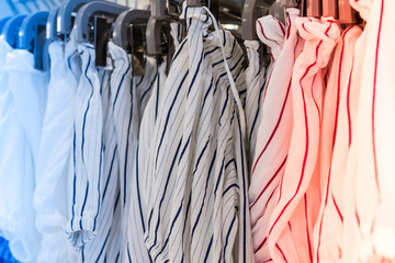 Close up of women clothes hanging in the store. Shopping mall. Fashion concept. Bali island.