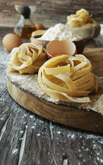 Uncooked pasta with flour on the table, selective focus