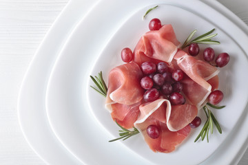 Jamon serrano with rosemary and grape .