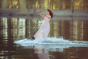 Woman in a dress is riding on the water park.