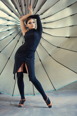 Elegant latin women dancers on big photo umbrella background