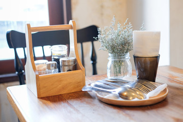 Beautiful houseplant in flowerpot, tissue in black box, garnish (pepper, toothpick, sauce) in...