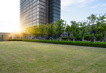 Fototapeta na wymiar modern office block with green lawn against sunlight,suzhou,china.