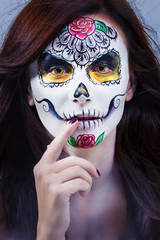 Portrait of a beautiful young woman in a Halloween style. Aquagrim - the skull