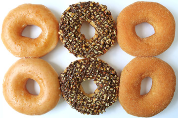 Six doughnuts in different flavors, top view for background and banner 