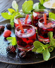 berry juice in a glass with berries, selective focus