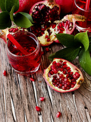 Fresh pomegranates and juice, selective focus