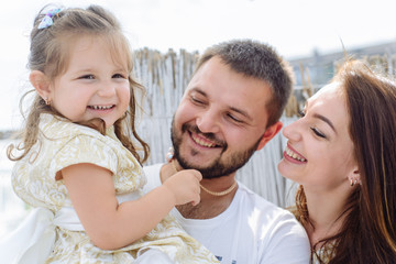 Fototapeta premium Happy loving family. portrait of mom with dad and daughter