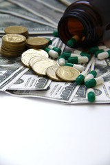 Expensive healthcare concept, Capsules and pills pouring from bottles, medicines on dollar on White Background