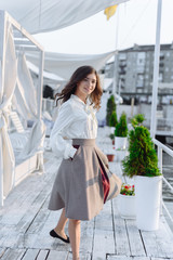 fashion portrait of happy beautiful girl in white shirt and casual dress