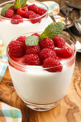 fresh yoghurt with raspberries in a glass