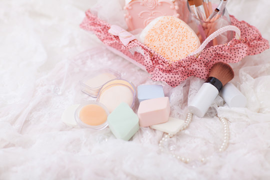 Candy color of Makeup puff and sponge with some cosmetic brush decorating.