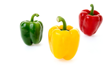 yellow green and red pepper on white background