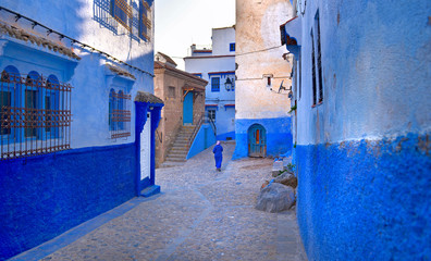 A Moroccan woman in national clothes is walking down the street of the city
