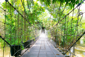 Wooden suspension bridge across over the river