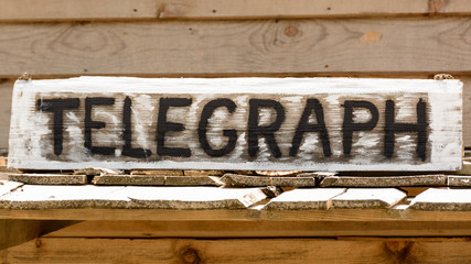 Telegraph inscription on the wooden board