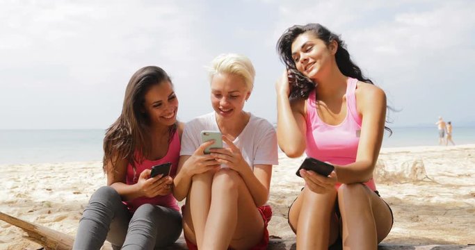 Grils Sitting On Beach Using Cell Smart Phones Talking, Young Women Communication Tourists Group Slow Motion 60