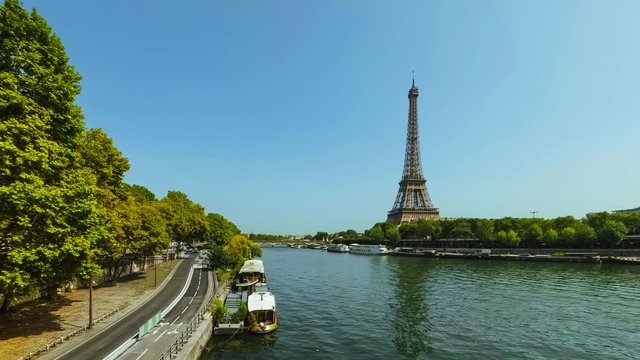 Street traffic time lapse near the Eiffel tower during rush hours in Paris, France. Summer cityscape, city life and famous touristic places and landmarks in Europe. Transportation and tourism concept