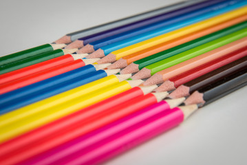 Rainbow of colors with school pencils school supplies and school accessories