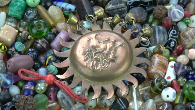 Rotating colorful various indian  old  beads and Shiva sign souvenir