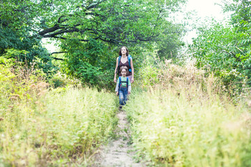 Boy and mom in the forest.