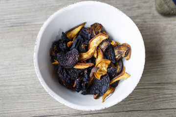 dry fruit in white bowl on wooden floor or table