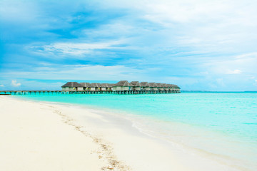 Fototapeta na wymiar Wooden villas over water of the Indian Ocean, Maldives